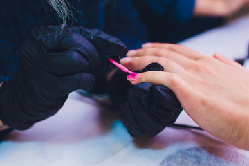 Close up of process france manicure at beauty salon.