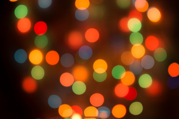 Festive lights on the Christmas tree, defocused lights for Christmas, New Year and a merry holiday background.