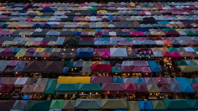 Night market called train night market Ratchada Time-lapse day to night bird eye view, people visit to enjoy many kind of street food, located at back of Esplanade Ratchadapisek Department store, Bang