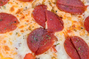 Salami pizza on wooden board on the table. Close-up view