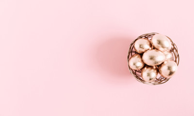Easter pink composition. Easter eggs on pastel pink background. Flat lay, top view, copy space