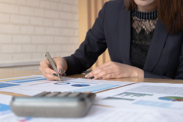 Businesswoman investment consultant analyzing company annual financial report balance sheet statement working with documents graphs. Concept picture of business, market, office, tax.