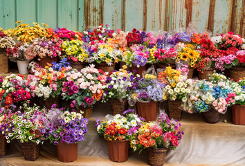 Beautiful multicolored artificial flowers background. flowers decor.