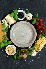 Food background with traditional ingredients for mediterranean cuisine over dark background. Top view with copy space. Italian food concept.
