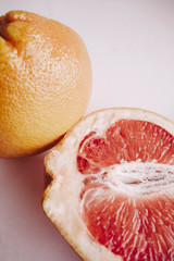 Halved juicy grapefruit. Vertical wallpaper 