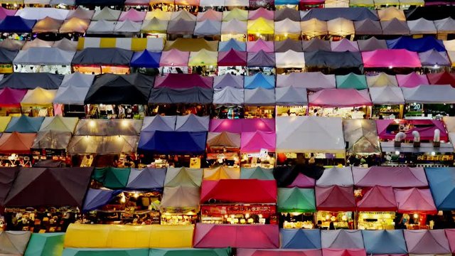 Night market called train night market Ratchada Time-lapse day to night bird eye view, people visit to enjoy many kind of street food, located at back of Esplanade Ratchadapisek Department store, Bang