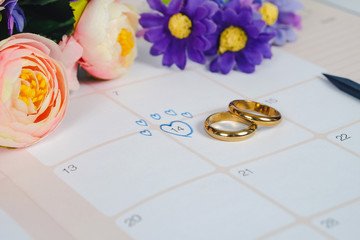 Word Wedding to Reminder Wedding day with Wedding ring on calendar planning and office tool.
