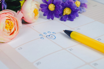 Word Wedding to Reminder Wedding day in calendar planning and pen with heart.