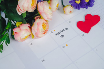 Word Wedding to Reminder Wedding day in calendar planning and pen with heart.