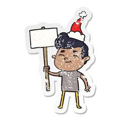 happy distressed sticker cartoon of a man with sign wearing santa hat