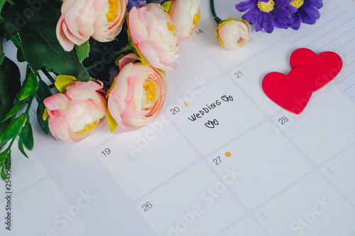 Word Wedding to Reminder Wedding day in calendar planning and pen with heart.