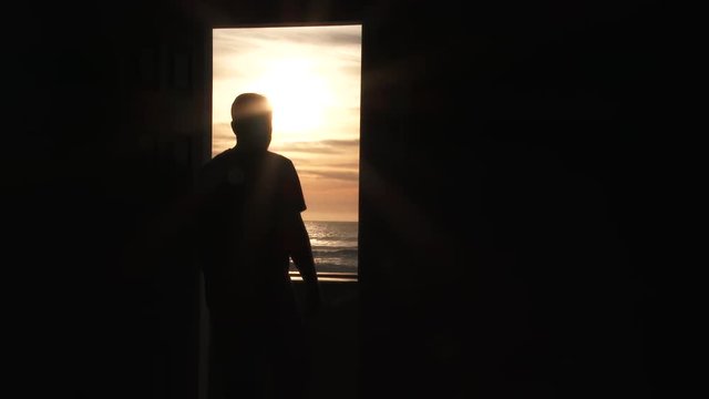 Person Opens Door To A Sunset Paradise