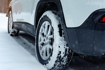 Modern car on snowy road, closeup view. Winter season