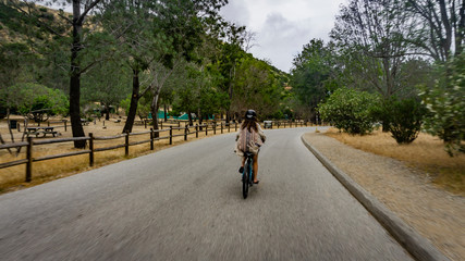 Obraz premium girl rides electric bicycle on Catalina island