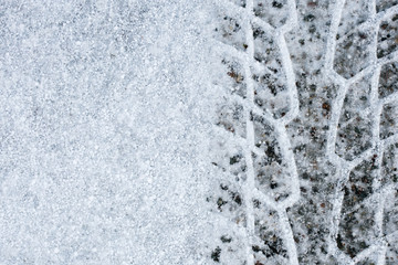 Imprint wheel tread on the snow. Weather forecast. Cooling.