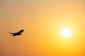 airplane taking off airport sky-diving industry cargo business, concept: passenger Commercial  modern navigable Travel and business,Silhouette aircraft is flying above skyline sun