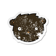 retro distressed sticker of a cartoon black bear head