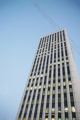 one skyscraper bottom view. business center on the background of a clear sky. gray residential complex