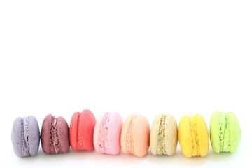 Line of colorful fresh sweet cake macaroons on the white background, have copy space for put text.