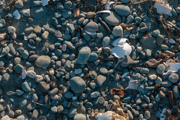 Beach sand and pebbles texture and background.