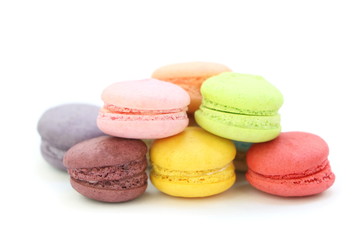 Fototapeta na wymiar Close up many colorful fresh macarons pile isolated on white background, look delicious
