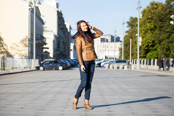 Young happy woman in brown leather jacket