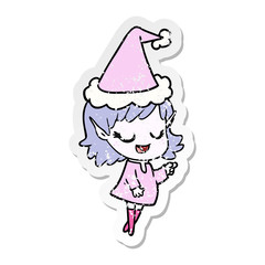 happy distressed sticker cartoon of a elf girl pointing wearing santa hat