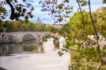 Fototapeta premium St. Peter's Basilica from a bridge with views of the Tiber River