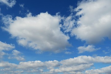 Naklejka na ściany i meble Beautiful fluffy clouds in blue sky, natural clouds background