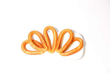 Naklejka premium served spanish fritters on white background