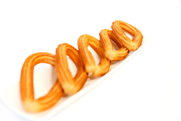 spanish fritters on white background