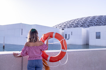 woman like a litte girl playing on the sun of dubai