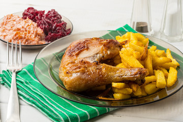 Roasted chicken legs with homemade french fries.