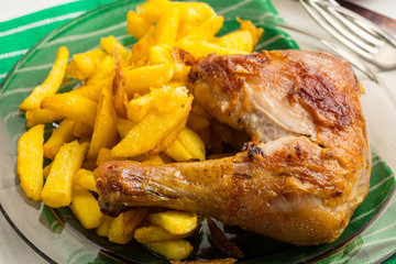 Roasted chicken legs with homemade french fries.