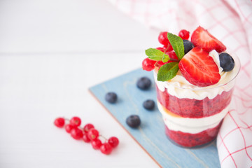 Cake dessert. Trifle red velvet in glass with fresh berries, mint leaves.