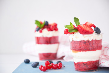 Cake dessert. Trifle red velvet in glass with fresh berries, mint leaves.