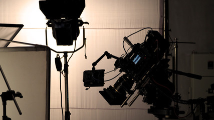 Video camera in film or movie production on tripod and professional gear which shooting in location...
