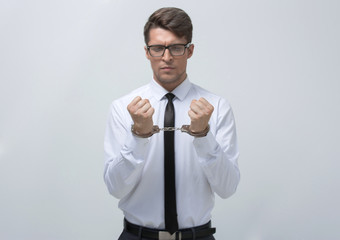 young businessman in handcuffs.