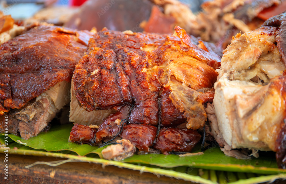 Wall mural roasted pork meat cooked on grill. traditional cuisine. sliced pork barbecue with gold skin