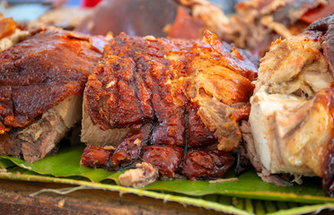 Roasted pork meat cooked on grill. Traditional cuisine. Sliced pork barbecue with gold skin