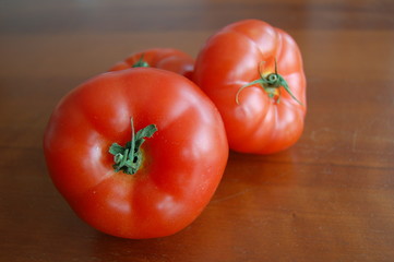 fresh tomatoes on wooden table