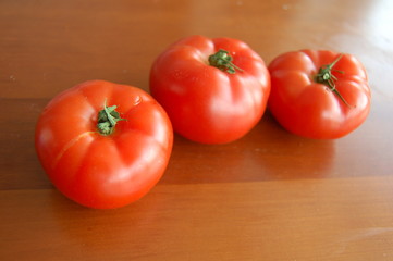 fresh tomatoes on wooden board