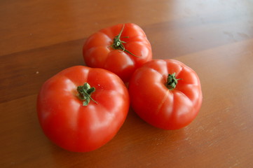 fresh tomatoes on wooden table