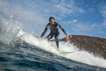 surfer riding waves on the island of fuerteventura in the Atlantic Ocean