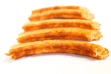 spanish fritters on white background
