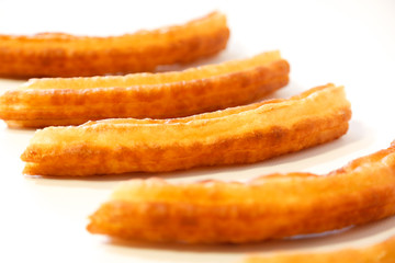 spanish fritters on white background