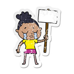 distressed sticker of a cartoon crying woman with protest sign