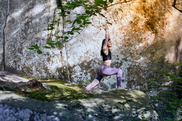 Young girl in mountains doing yoga exercise outdoor