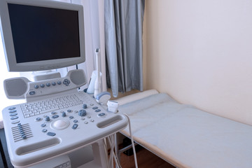 Complex ultrasound. A lying place and a modern medical device in the clinic. Health research and prevention. Daylight. Copy space.