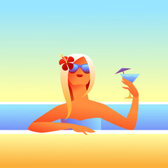 Girl sunbathes on beach with cocktail.
